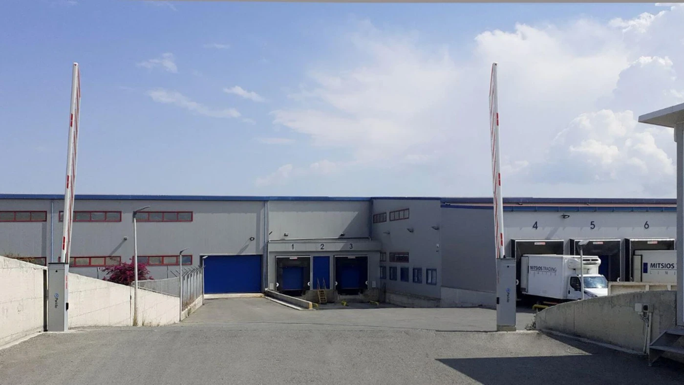 Raised boom barriers at a factory vehicle entrance